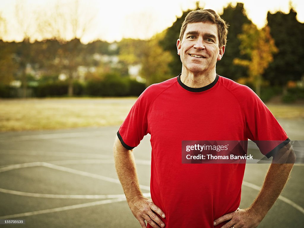 Mature basketball player standing on outdoor court