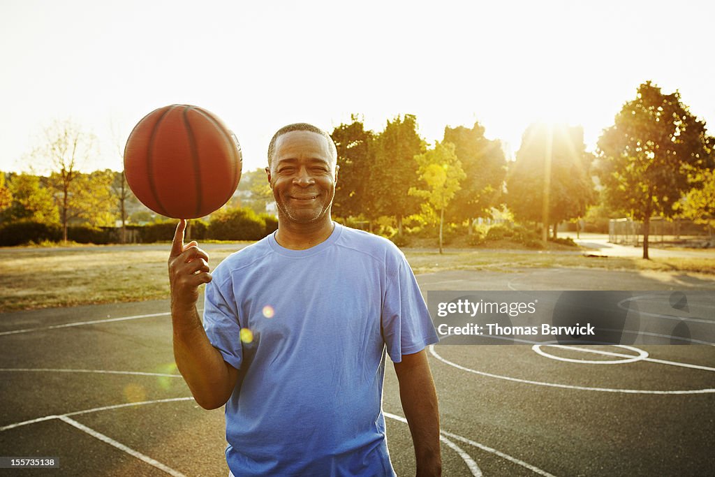 Basketball player spinning ball on fingertip