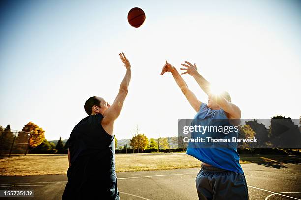 basketball player shooting over defending player - tough decisions stock pictures, royalty-free photos & images