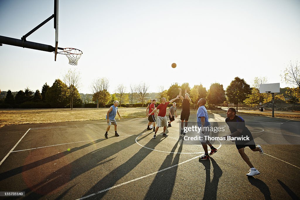 Group of senior and mature men playing basketball