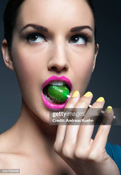 young woman with lollipop in her mouth. - confectionery stock pictures, royalty-free photos & images