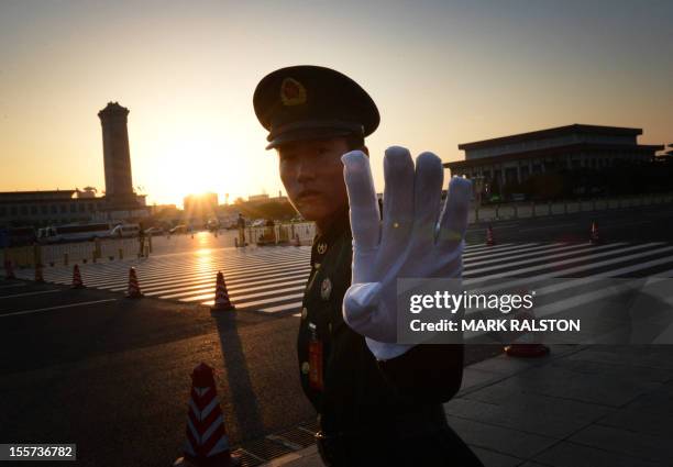 Chinese paramilitary policeman reacts outside the opening session of the Chinese Communist Party's five-yearly Congress at the Great Hall of the...
