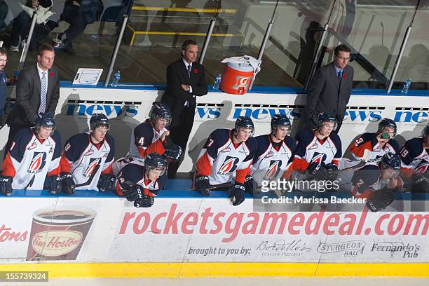 Ed Patterson, coach, Guy Charron, head coach, and Dave Hunchak, coach of the Kamloops Blazers stand on the bench at the Kelowna Rockets on November...