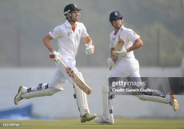 Alastair Cook and Nick Compton of England score runs during the tour match between England and Haryana at Sardar Patel Stadium ground B on November...