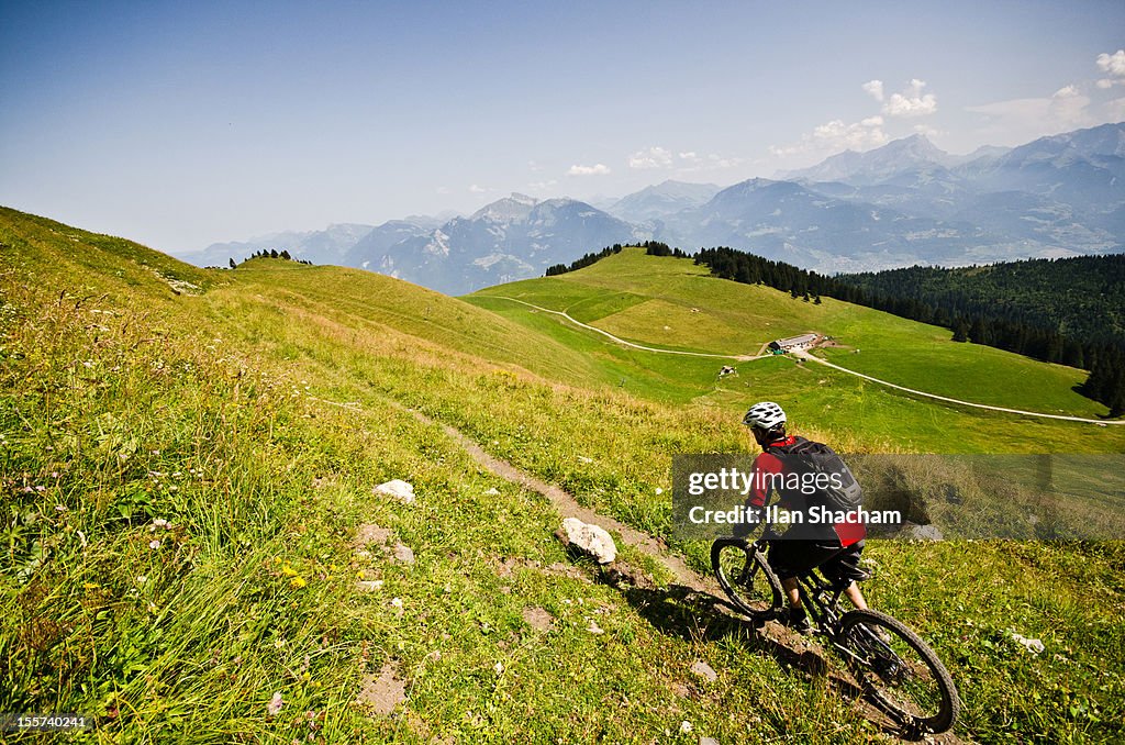 Single Track Riding Riding A Singletrack On A Green Mountainside High-Res Stock Photo ...