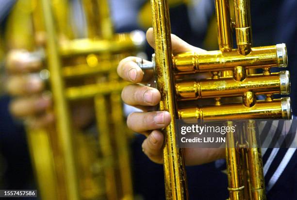 Soldiers from Chinese navy brass band hold the trumpets during a performance ahead a friendly basketball match between Chinese navy's team and the...