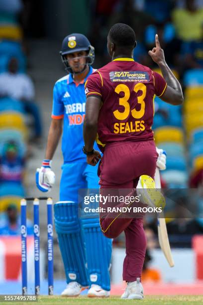 Jayden Seales of West Indies celebrates the dismissal of Shubman Gill of India during the first One Day International cricket match between West...