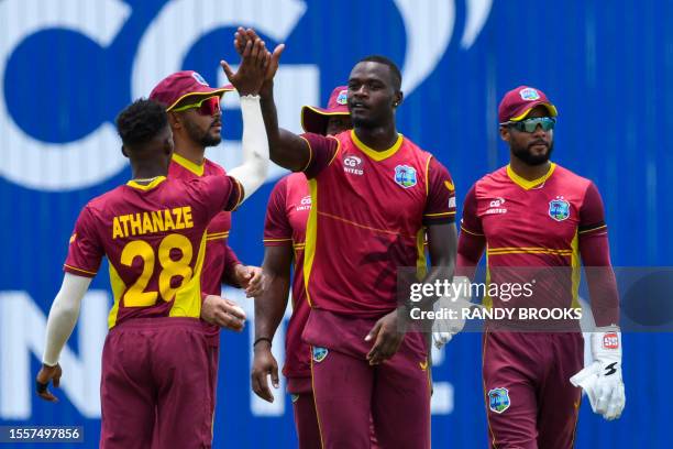 Jayden Seales , Shai Hope and Brandon King of West Indies celebrate the dismissal of Shubman Gill of India during the first One Day International...