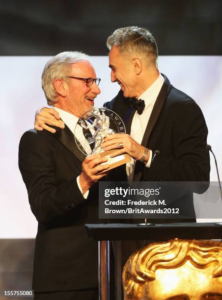 Honoree Daniel Day-Lewis accepts The Stanley Kubrick Britannia Award for Excellence in Film from presenter Steven Spielberg onstage at the 2012 BAFTA...