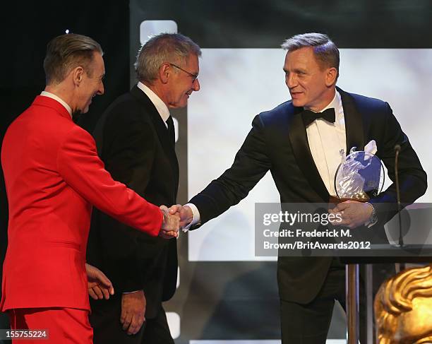 Alan Cumming and Harrison Ford present the Britannia Award for British Artist of the Year to Honoree Daniel Craig onstage at the 2012 BAFTA Los...