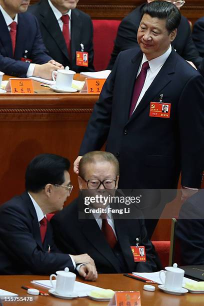 Chinese Vice President Xi Jinping walks past Chinese President Hu Jintao, front left, and former Chinese President Jiang Zemin, front right, during...