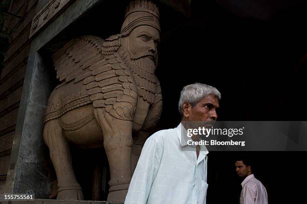 Men walk down a street in Mumbai, India, on Tuesday, Nov. 6, 2012. Reserve Bank of India Governor Duvvuri Subbarao lowered the RBI’s forecast for...