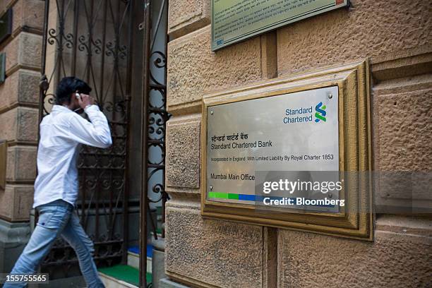 Man enters a Standard Chartered Plc bank branch in the Fort area of Mumbai, India, on Tuesday, Nov. 6, 2012. Reserve Bank of India Governor Duvvuri...