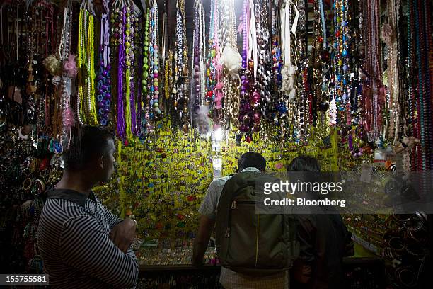 Men shop for jewelry in the Colaba area of Mumbai, India, on Tuesday, Nov. 6, 2012. Reserve Bank of India Governor Duvvuri Subbarao lowered the RBI’s...