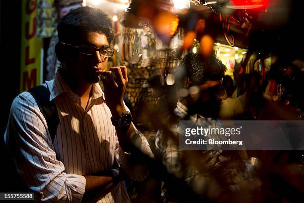 Man shops for spectacles in the Colaba area of Mumbai, India, on Tuesday, Nov. 6, 2012. Reserve Bank of India Governor Duvvuri Subbarao lowered the...