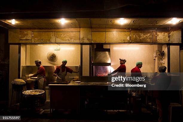 Men prepare food at a restaurant in the Colaba area of Mumbai, India, on Tuesday, Nov. 6, 2012. Reserve Bank of India Governor Duvvuri Subbarao...