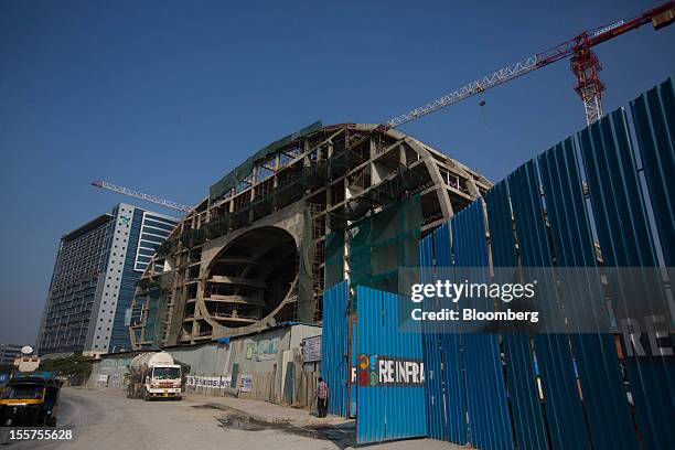 Building stands under construction next to the Standard Chartered Plc building, left, in the Bandra Kurla Complex in Mumbai, India, on Tuesday, Nov....