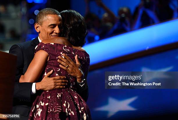 First lady Michelle Obama hugs President Barack Obama after introducing him before his nomination acceptance speech during the final night of the...