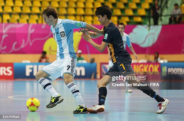 Tobias Seeto of Australia tries to tackle Leandro Cuzzolino of Argentina during the FIFA Futsal World Cup Thailand 2012, Group D match between...