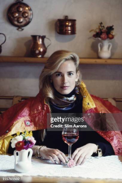 Linsday McCrum, a New York painter and printmaker, with a ski jacket draped over her shoulders as she poses with a glass of wine in Cortina...