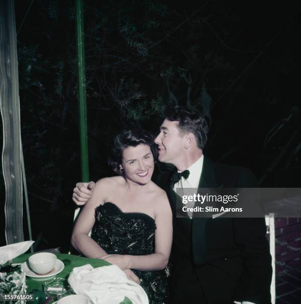 Photographer Slim Aarons with his arm around a woman at a Christmas Eve party, in Beverly Hills, California, USA, 24 December 1951. The party was...