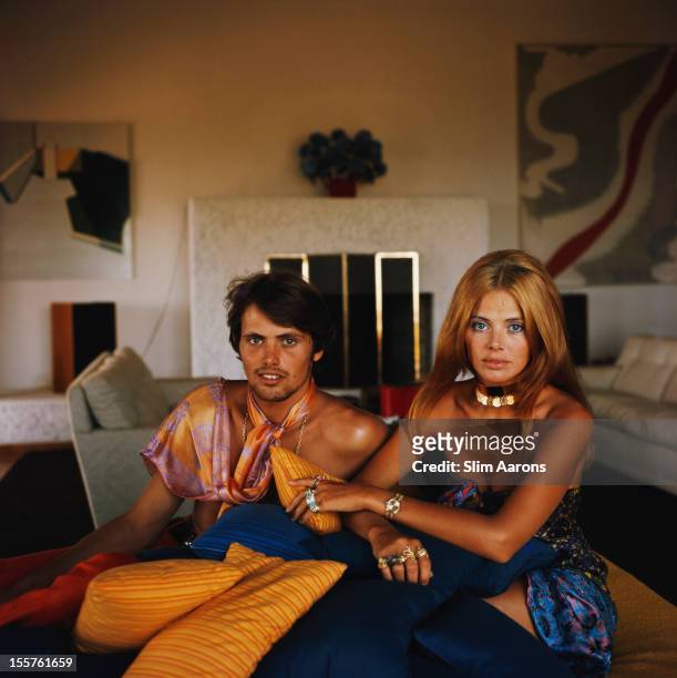 Britt Ekland, Swedish actress, and her brother, sitting with a pile of small cushions in Porto Ercole, Italy, circa 1975.