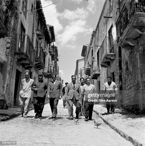 Mafia boss Charles 'Lucky' Luciano walking with his henchmen in Sicily, Italy, 31 December 1948.