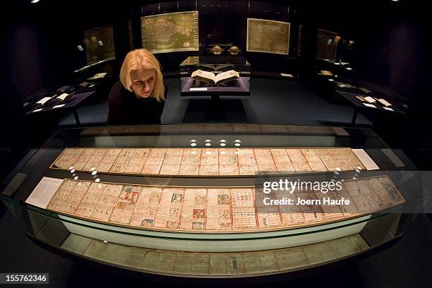 Visitor, at the request of the photographer, looks at the 12th-century Dresden Codex, also known as the "Codex Dresdensis", one of four historic...
