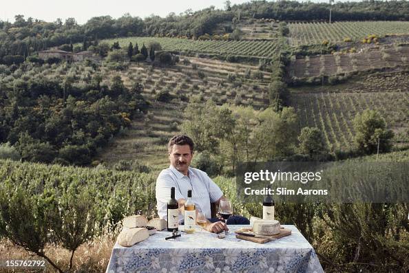 Mauri Castel Italian winemaker Maurizio Castelli sitting at a table, on which are ...