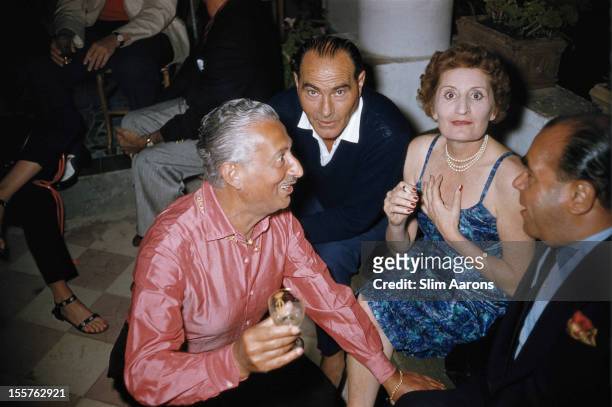 Edda Ciano, Countess of Cortellazzo and Buccari , sitting with Pietro Capuano and two other men on the island of Capri, Italy, in July 1958. Ciano is...