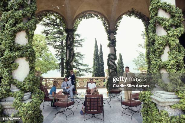 Italian mountain climber and explorer Guido Monzino and four people relaxing on the terrace of Monzino's home, Villa del Balbianello in Lenno,...