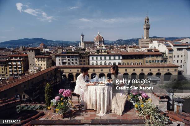 Santa Antonelli and Serena Antonelli dining al fresco on the terrace of their home above Via Giucciardini, in Florence, Italy, in June 1983. Rising...