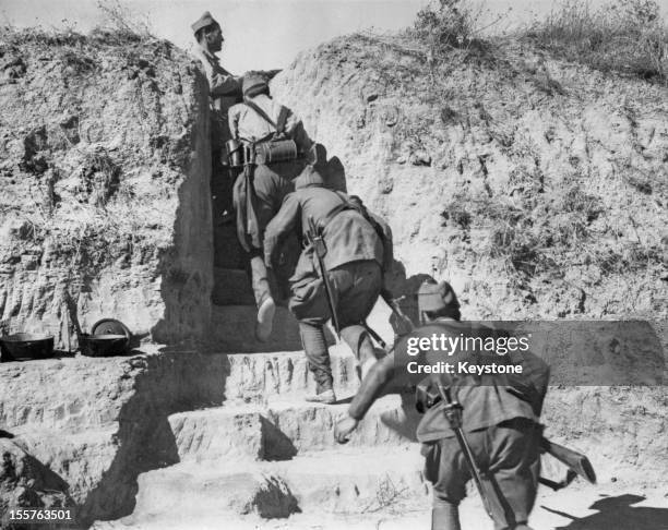Republican troops of the International Brigades moving into a communications trench at Navalcarnero, near Madrid, at the beginning of the Nationalist...