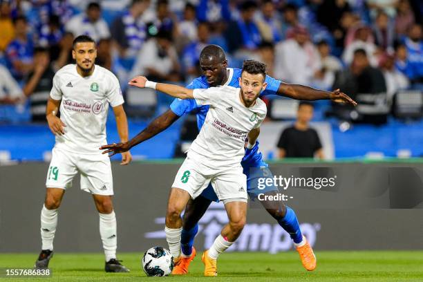 Hilal's Senegalese defender Kalidou Koulibaly vies for the ball against Al-Ahli's Libyan midfielder Noor Aldeen al-Qulaib during the 2023 Arab Club...