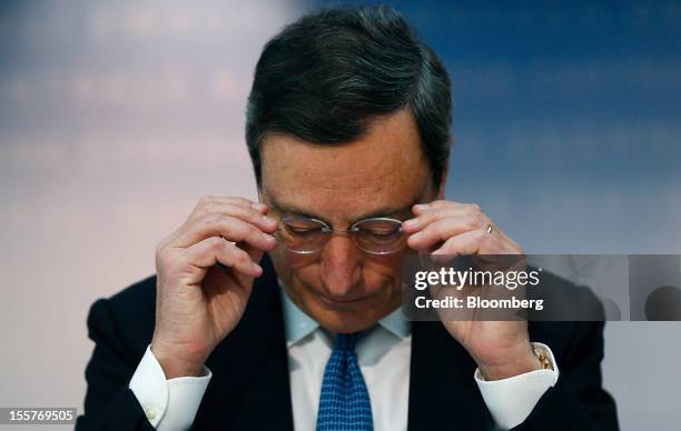 Mario Draghi, president of the European Central Bank , adjusts his spectacles during a news conference at the bank's headquarters in Frankfurt,...