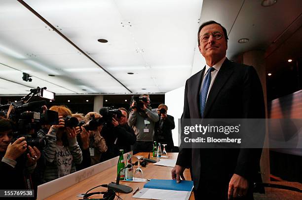 Mario Draghi, president of the European Central Bank , right, poses for a photograph ahead of a news conference at the bank's headquarters in...