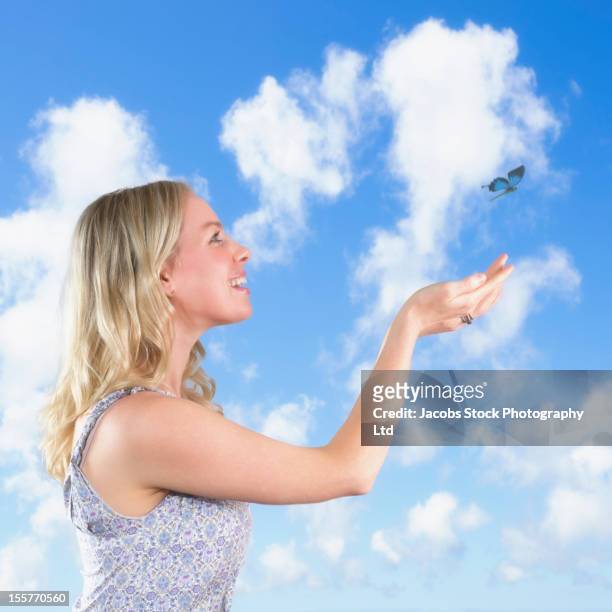 caucasian woman catching a butterfly - catching butterfly stock pictures, royalty-free photos & images