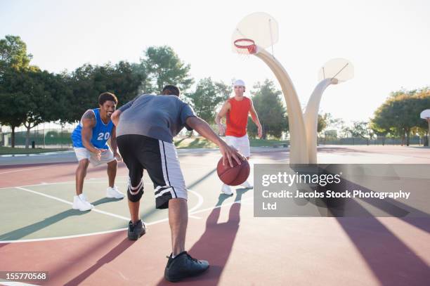 friends playing basketball - playing basketball in park stock pictures, royalty-free photos & images