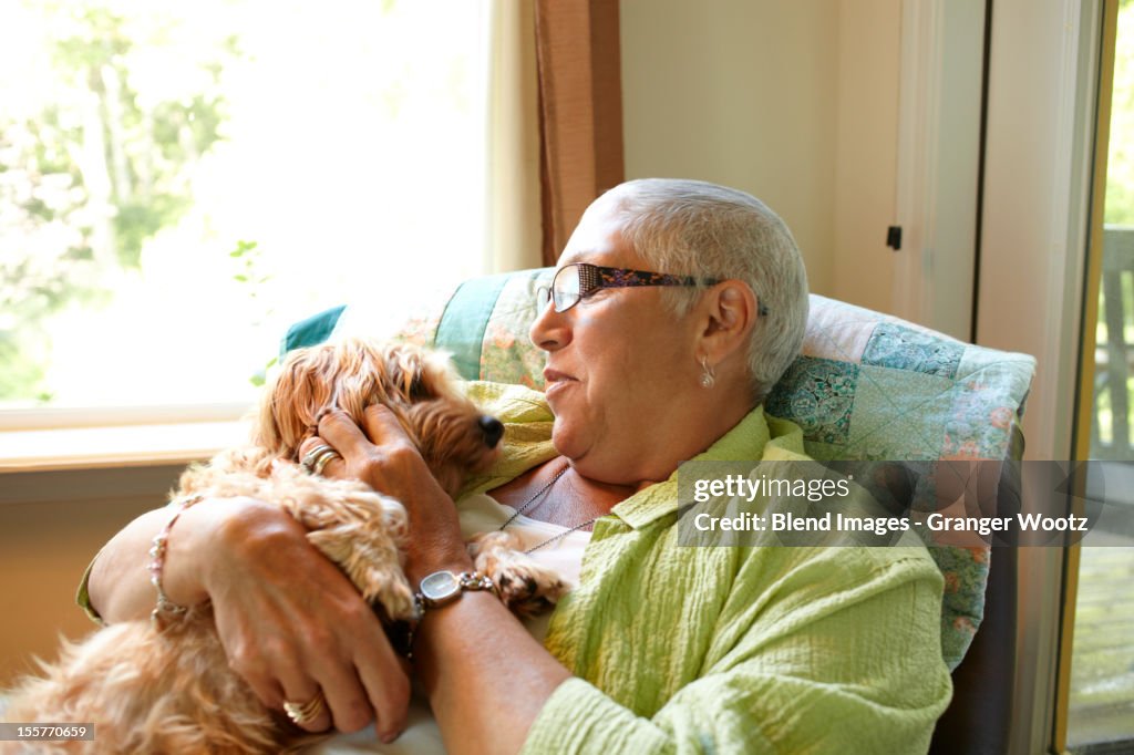 Caucasian woman holding dog