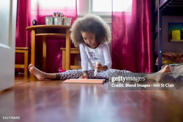 mixed race girl sitting on floor drawing - art and craft stock pictures, royalty-free photos & images