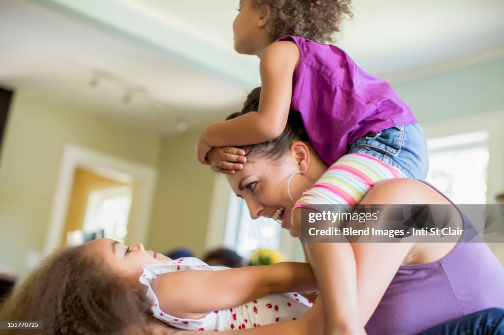 Mother and daughters playing