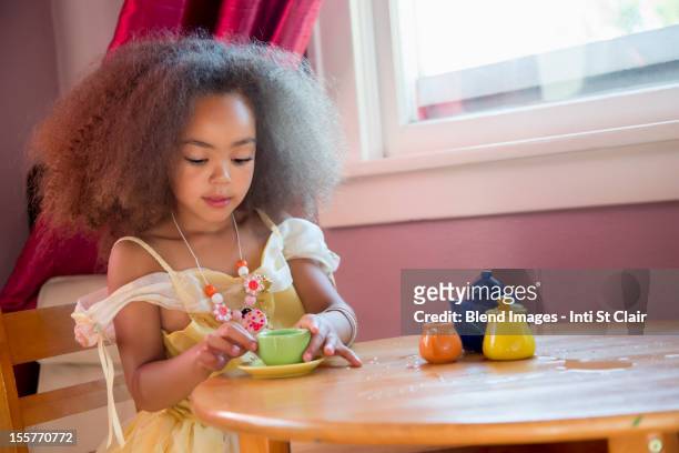 mixed race girl having tea party - tea party stock pictures, royalty-free photos & images