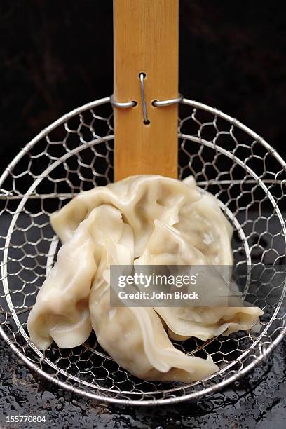 asian dumplings in strainer - fried dough stock pictures, royalty-free photos & images