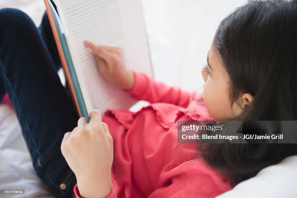 Mixed race girl reading a book