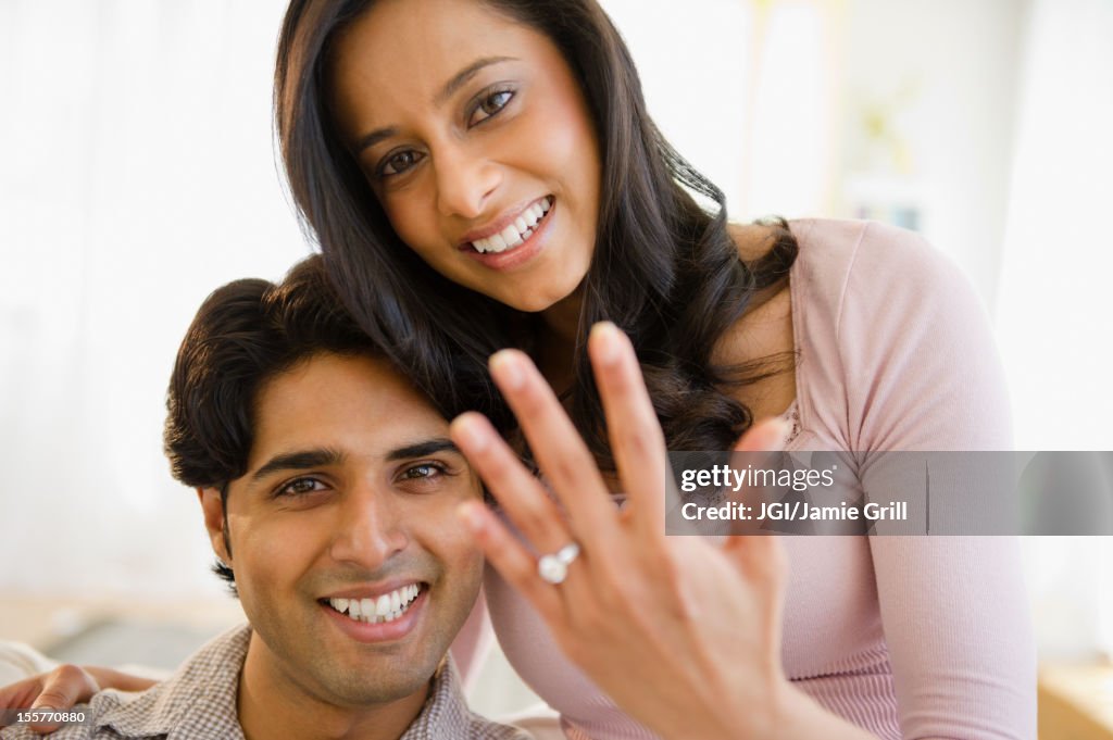 Mixed race woman showing off engagement ring