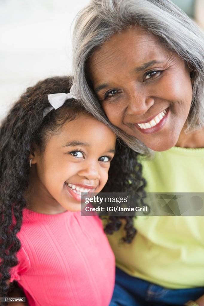 Smiling African American grandmother and granddaughter