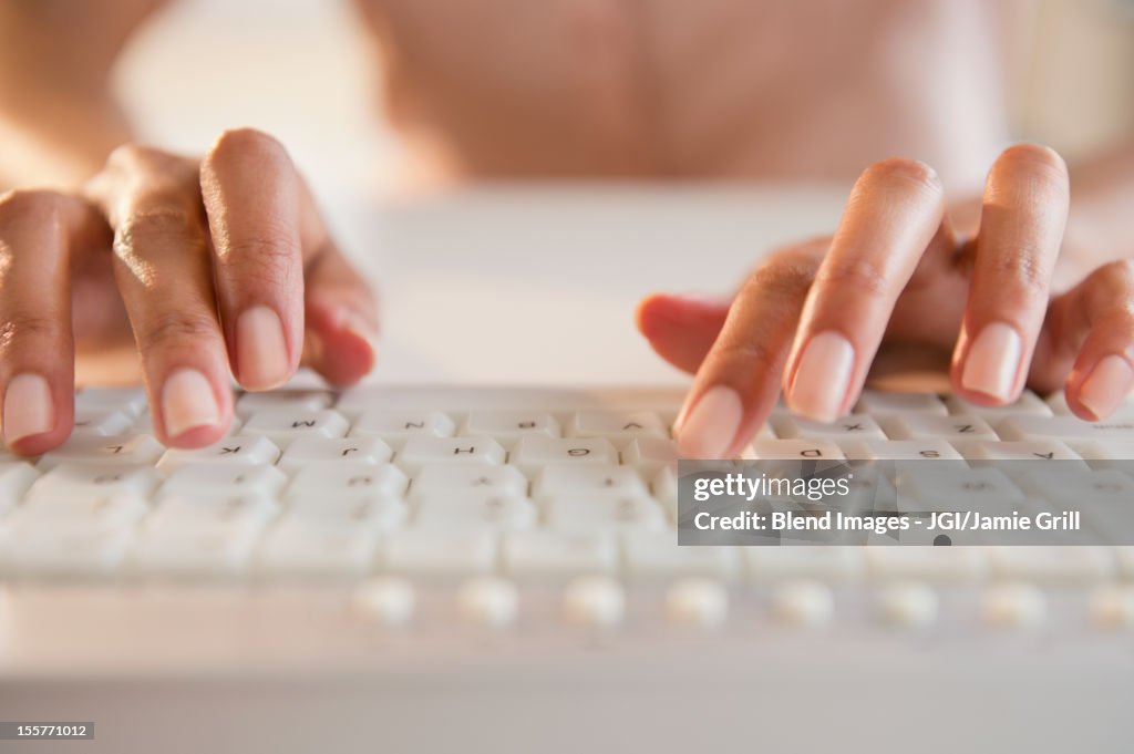 Cape Verdean woman typing on keyboard