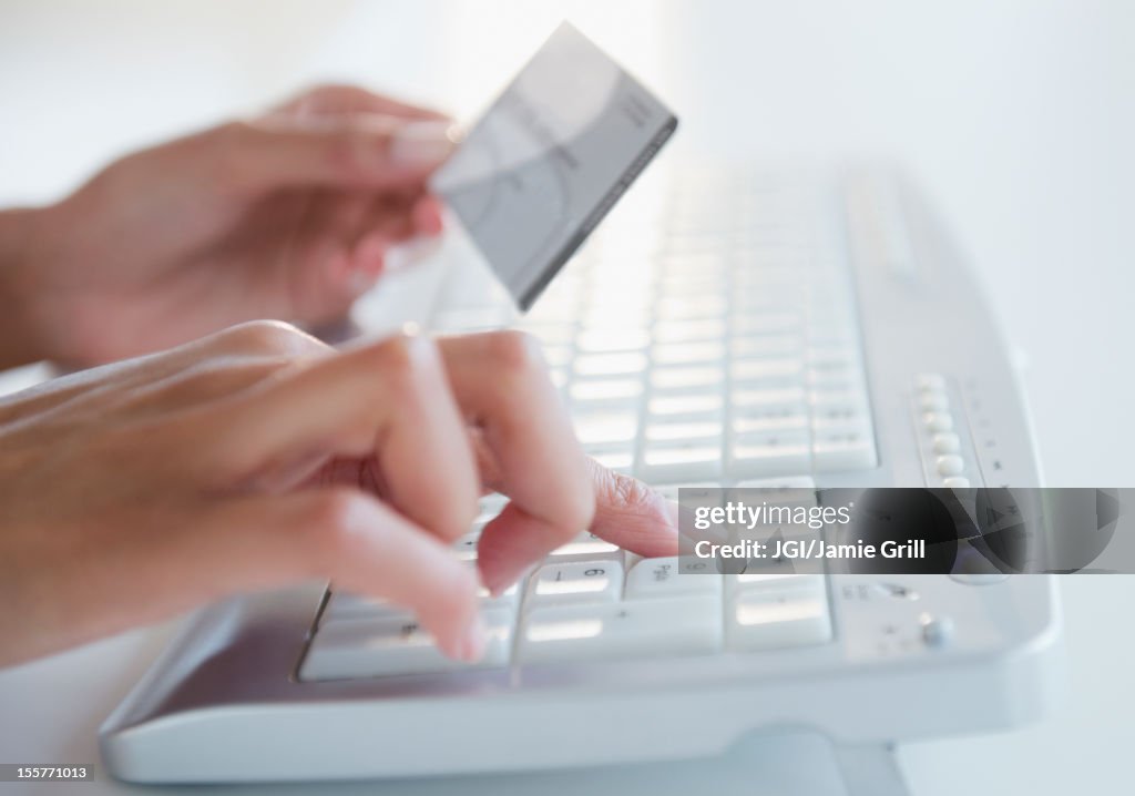 Cape Verdean woman shopping online with credit card