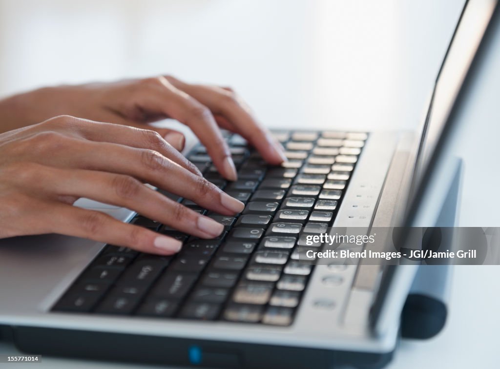Cape Verdean woman typing on laptop