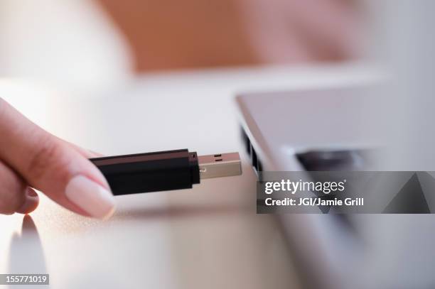 cape verdean woman using usb device - usb flash drive stock pictures, royalty-free photos & images